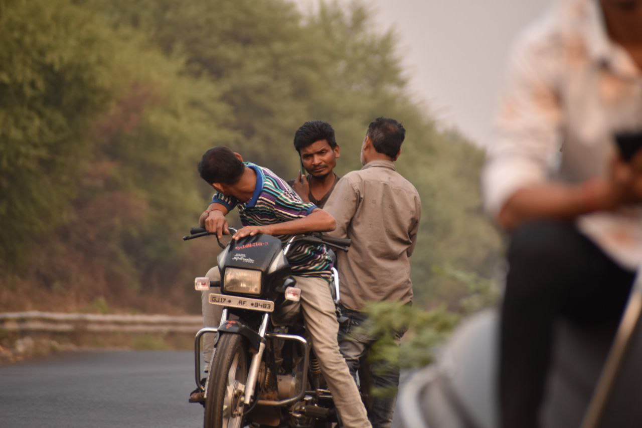 a man riding a motorcycle with a kid on the back